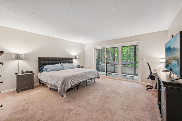 3137 Griggsview Ct Unit 3137, Columbus, OH 43221 - bedroom with access to exterior, light carpet, a textured ceiling, baseboards, and a desk
