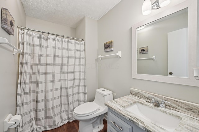 3137 Griggsview Ct Unit 3137, Columbus, OH 43221 - bathroom featuring vanity, toilet, a textured ceiling, wood finished floors, and a shower with shower curtain