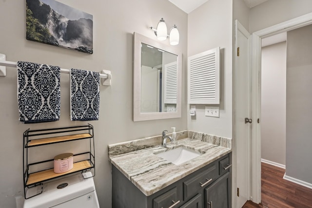 3137 Griggsview Ct Unit 3137, Columbus, OH 43221 - bathroom with wood finished floors, vanity, baseboards, and toilet