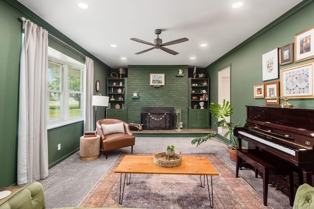 776 Galloway Rd, Galloway, OH 43119 - carpeted living room featuring ceiling fan, crown molding, recessed lighting, a brick fireplace, and baseboards