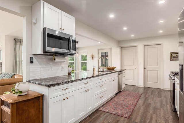 776 Galloway Rd, Galloway, OH 43119 - kitchen with stainless steel appliances, a sink, recessed lighting, dark wood-type flooring, and dark stone countertops