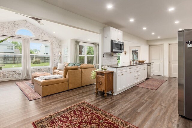776 Galloway Rd, Galloway, OH 43119 - kitchen featuring appliances with stainless steel finishes, white cabinets, vaulted ceiling, a sink, and dark wood-style flooring