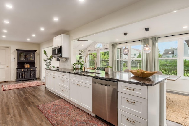 776 Galloway Rd, Galloway, OH 43119 - kitchen with stainless steel appliances, a sink, dark wood-style flooring, white cabinetry, and dark stone counters