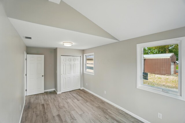 4881 Decker Ave NE, Thornville, OH 43076 - unfurnished bedroom with multiple windows, wood finished floors, baseboards, and a closet