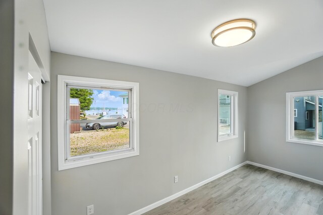 4881 Decker Ave NE, Thornville, OH 43076 - empty room featuring wood finished floors, baseboards, and lofted ceiling