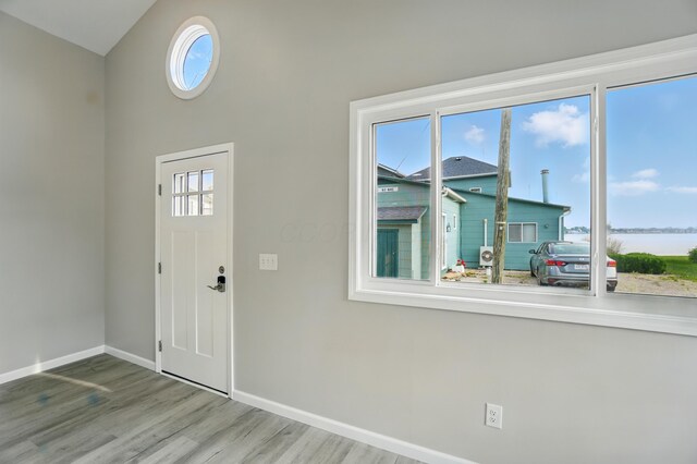 4881 Decker Ave NE, Thornville, OH 43076 - entryway with baseboards, wood finished floors, plenty of natural light, and a water view