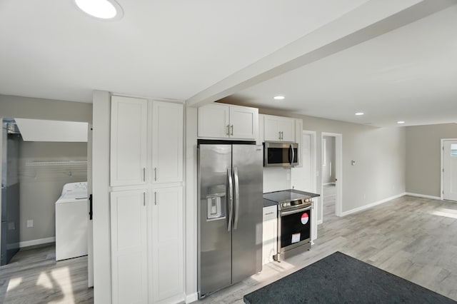 4881 Decker Ave NE, Thornville, OH 43076 - kitchen with stainless steel appliances, washer / dryer, baseboards, white cabinets, and recessed lighting