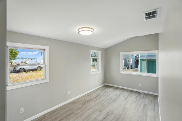 4881 Decker Ave NE, Thornville, OH 43076 - spare room with healthy amount of natural light, light wood finished floors, baseboards, and lofted ceiling