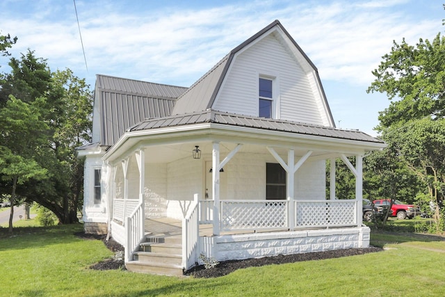 800 S Detroit St, Bellefontaine, OH 43311 - view of front of house featuring covered porch, a gambrel roof, metal roof, and a front yard