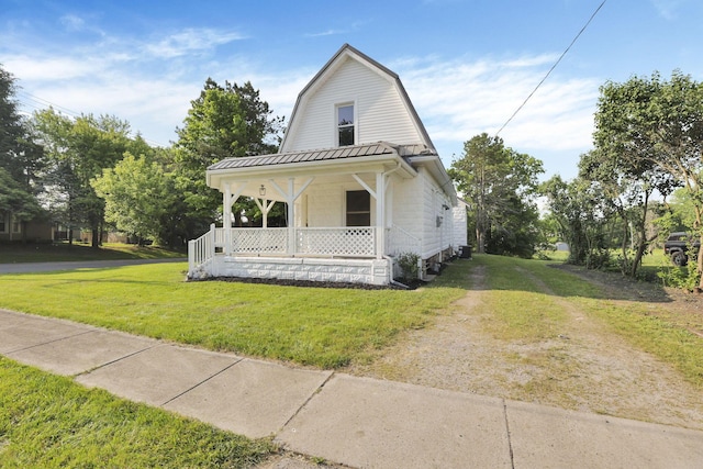 800 S Detroit St, Bellefontaine, OH 43311 - colonial inspired home with a porch, a gambrel roof, a front yard, and metal roof