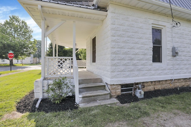 800 S Detroit St, Bellefontaine, OH 43311 - view of exterior entry with metal roof, covered porch, and a yard