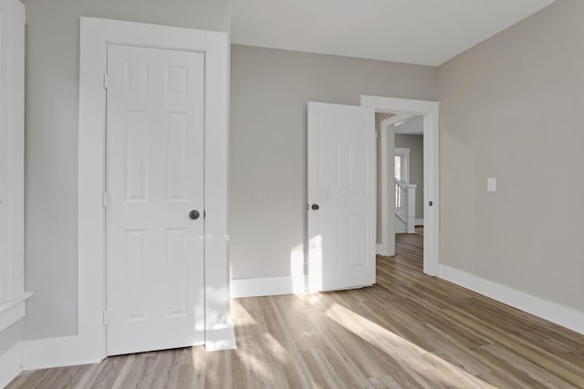 800 S Detroit St, Bellefontaine, OH 43311 - unfurnished bedroom featuring light wood-type flooring and baseboards
