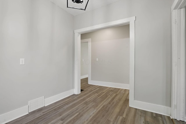 800 S Detroit St, Bellefontaine, OH 43311 - unfurnished dining area with wood finished floors, baseboards, and a chandelier