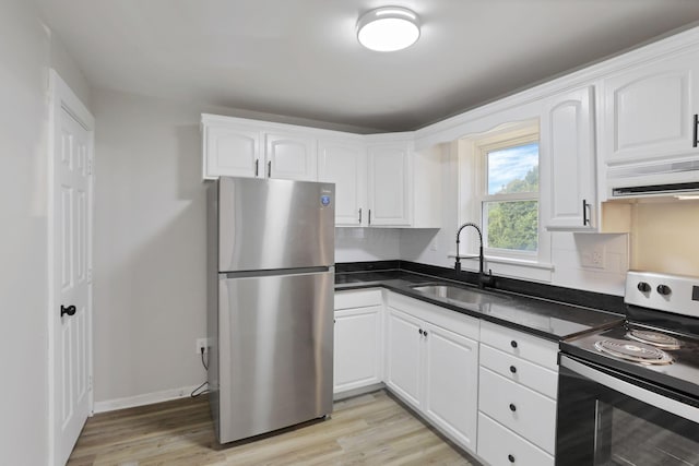 800 S Detroit St, Bellefontaine, OH 43311 - kitchen featuring appliances with stainless steel finishes, a sink, white cabinetry, and light wood-type flooring