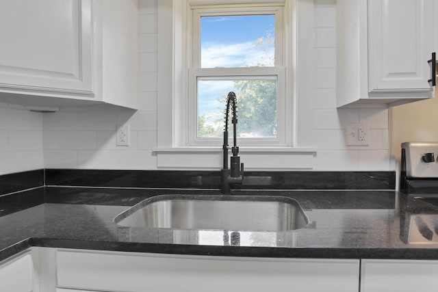 800 S Detroit St, Bellefontaine, OH 43311 - kitchen featuring a sink, white cabinets, decorative backsplash, and dark stone countertops