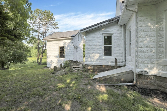 800 S Detroit St, Bellefontaine, OH 43311 - view of home's exterior featuring metal roof, a lawn, and entry steps