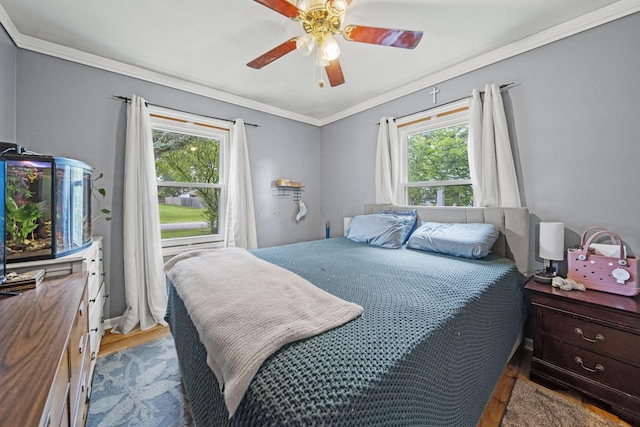 2107 Radnor Ave, Columbus, OH 43224 - bedroom featuring multiple windows, wood finished floors, crown molding, and ceiling fan