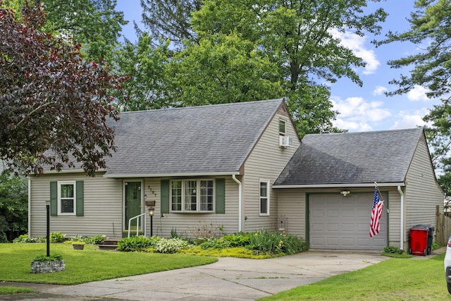 2107 Radnor Ave, Columbus, OH 43224 - cape cod house featuring an attached garage, driveway, roof with shingles, a front lawn, and cooling unit