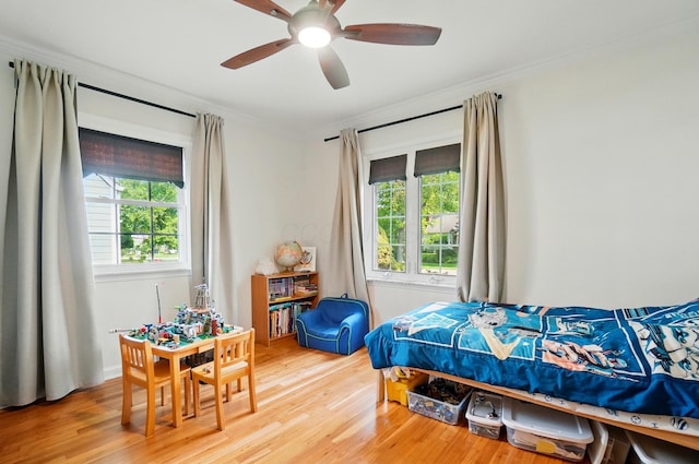 91 Nottingham Rd, Columbus, OH 43214 - bedroom featuring multiple windows, crown molding, wood finished floors, and a ceiling fan