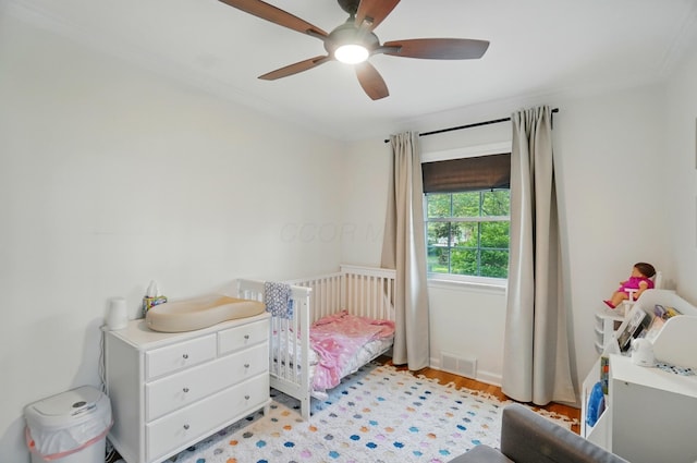 91 Nottingham Rd, Columbus, OH 43214 - bedroom with crown molding, a ceiling fan, and light wood-style flooring