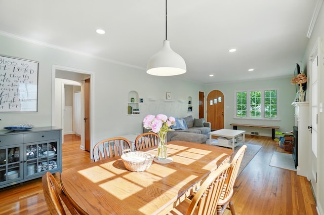 91 Nottingham Rd, Columbus, OH 43214 - dining space featuring arched walkways, crown molding, light wood-style floors, and recessed lighting