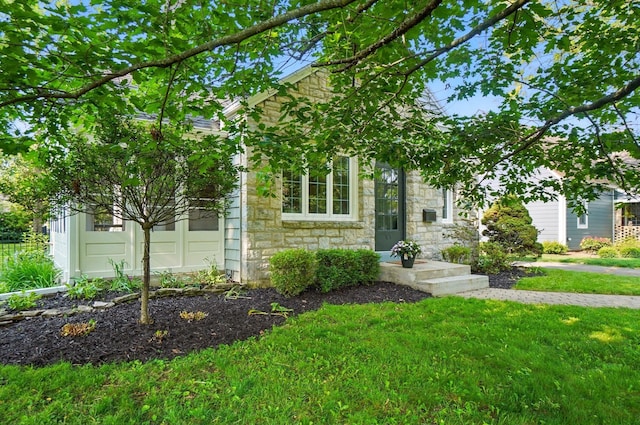 91 Nottingham Rd, Columbus, OH 43214 - obstructed view of property with stone siding and a front lawn