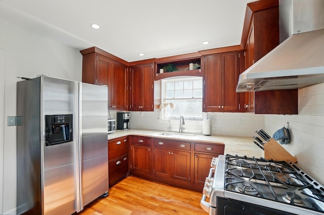 91 Nottingham Rd, Columbus, OH 43214 - kitchen with appliances with stainless steel finishes, wall chimney exhaust hood, a sink, backsplash, and light stone counters