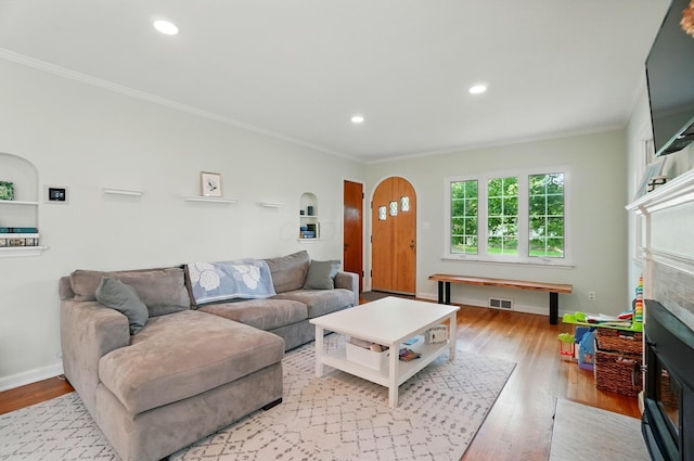 91 Nottingham Rd, Columbus, OH 43214 - living area featuring a fireplace, ornamental molding, arched walkways, light wood finished floors, and recessed lighting
