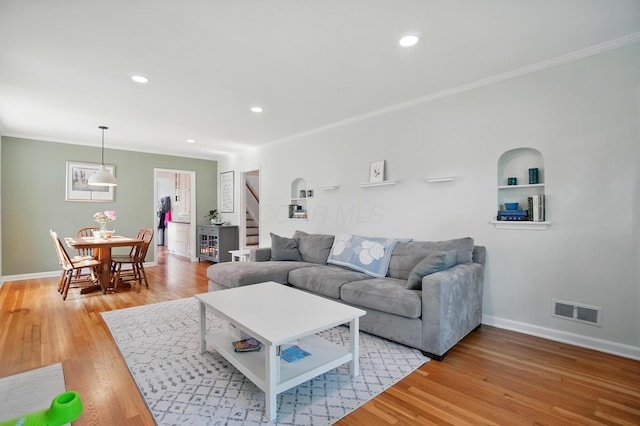 91 Nottingham Rd, Columbus, OH 43214 - living area with stairway, ornamental molding, light wood-style floors, baseboards, and recessed lighting