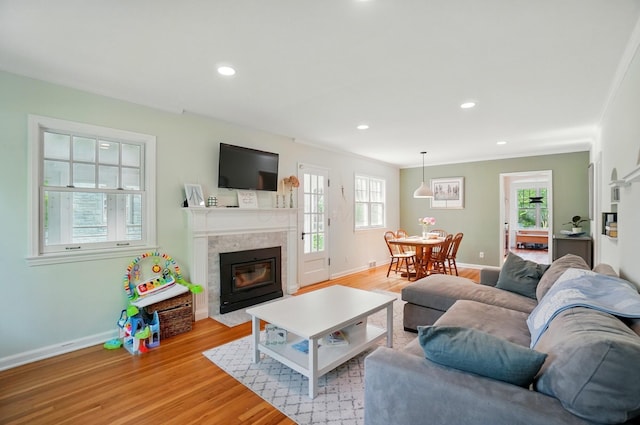 91 Nottingham Rd, Columbus, OH 43214 - living room with a premium fireplace, healthy amount of natural light, light wood finished floors, baseboards, and recessed lighting