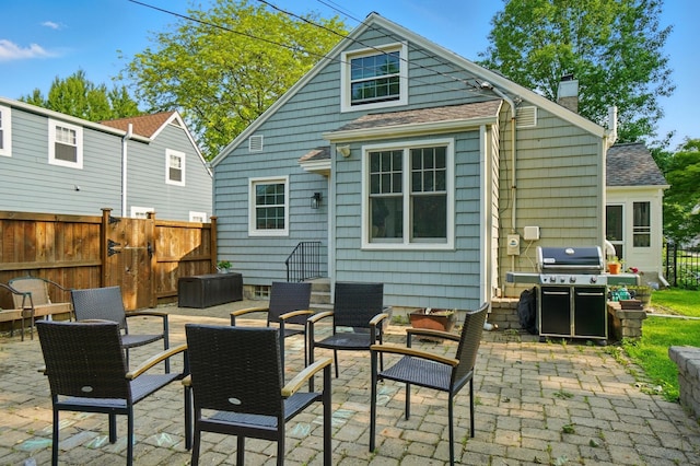 91 Nottingham Rd, Columbus, OH 43214 - back of property with a patio area, a chimney, a shingled roof, and an outdoor hangout area