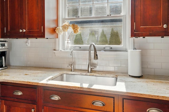 91 Nottingham Rd, Columbus, OH 43214 - kitchen featuring a sink, tasteful backsplash, dark brown cabinets, and light stone counters