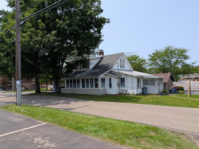 54 W High St, Mount Gilead, OH 43338 - view of front of house featuring a chimney, a front lawn, and roof with shingles