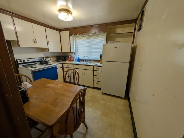 54 W High St, Mount Gilead, OH 43338 - kitchen featuring white appliances, light flooring, a sink, light countertops, and white cabinets