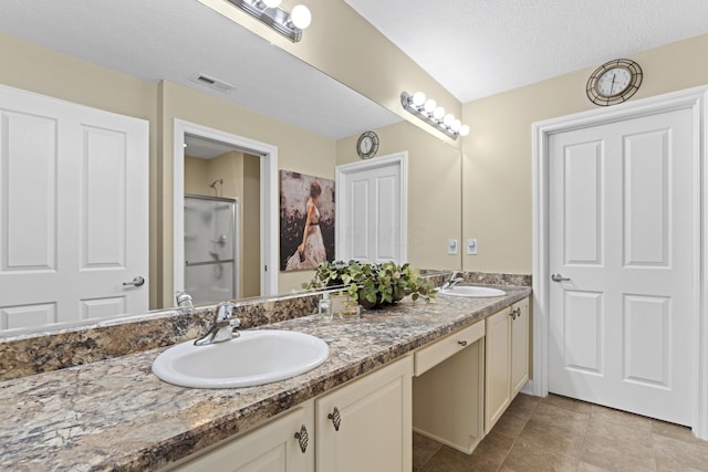 200 Jamie Lynn Cir, Pickerington, OH 43147 - full bath featuring double vanity, tile patterned flooring, a shower with shower door, and a textured ceiling