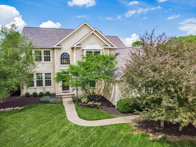 6810 Bearclover Dr, Dublin, OH 43016 - view of front of property featuring stucco siding, roof with shingles, and a front yard
