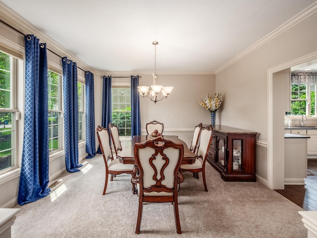 6810 Bearclover Dr, Dublin, OH 43016 - carpeted dining area featuring a chandelier, a sink, crown molding, and baseboards