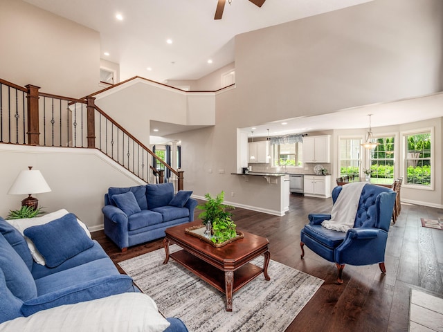 6810 Bearclover Dr, Dublin, OH 43016 - living room featuring stairway, dark wood finished floors, a ceiling fan, recessed lighting, and a high ceiling