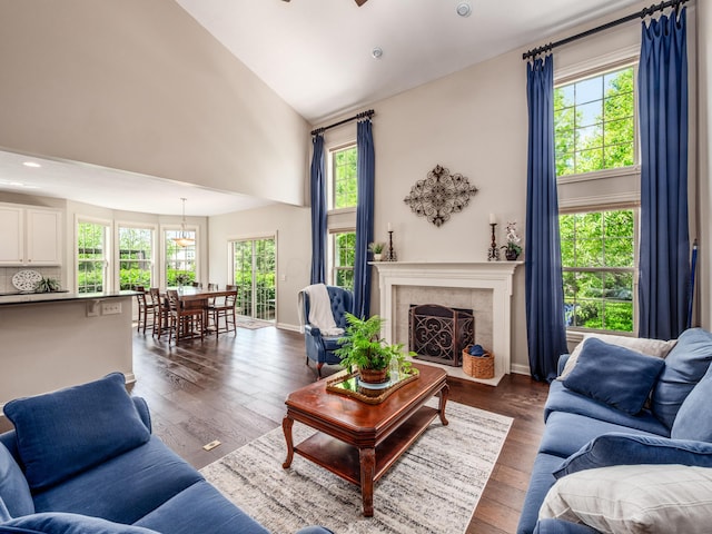 6810 Bearclover Dr, Dublin, OH 43016 - living area with high vaulted ceiling, dark wood-style flooring, a tiled fireplace, ceiling fan, and recessed lighting