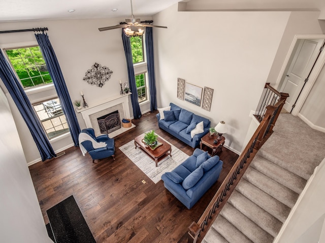 6810 Bearclover Dr, Dublin, OH 43016 - living room with stairway, wood finished floors, a fireplace with flush hearth, baseboards, and a ceiling fan