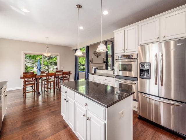 6810 Bearclover Dr, Dublin, OH 43016 - kitchen featuring appliances with stainless steel finishes, recessed lighting, a center island, white cabinetry, and hanging light fixtures