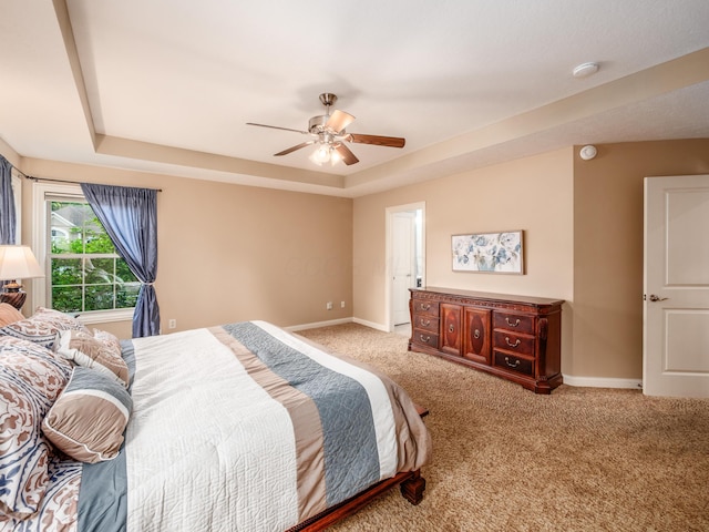 6810 Bearclover Dr, Dublin, OH 43016 - carpeted bedroom featuring baseboards, a tray ceiling, and a ceiling fan