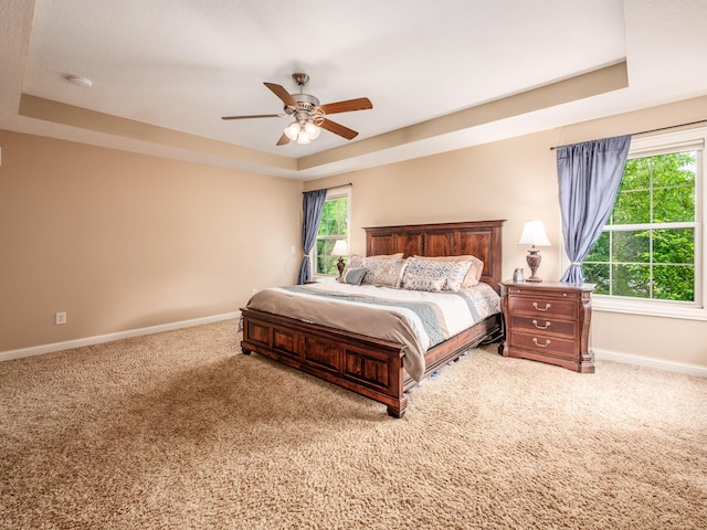 6810 Bearclover Dr, Dublin, OH 43016 - carpeted bedroom featuring baseboards, a tray ceiling, and ceiling fan