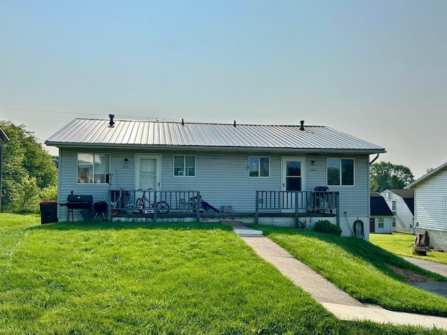 304 Montgomery Ave, Newark, OH 43055 - view of front of home featuring covered porch, a front lawn, and metal roof