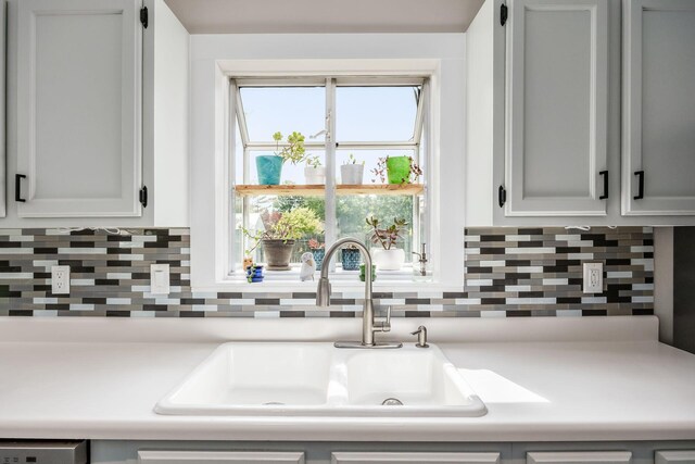 5999 Waterview Dr, Hilliard, OH 43026 - kitchen featuring a sink, light countertops, decorative backsplash, and dishwasher