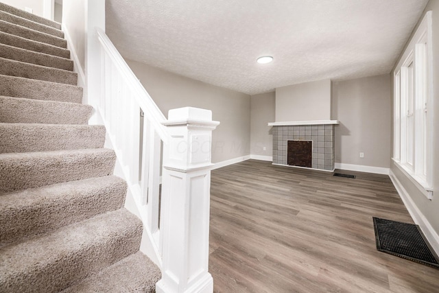 960 Carpenter St, Columbus, OH 43206 - unfurnished living room with baseboards, stairway, wood finished floors, a textured ceiling, and recessed lighting
