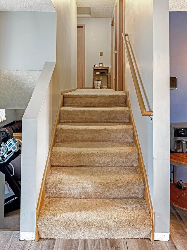 4890 Township Road 138 NW, Somerset, OH 43783 - stairs featuring wood finished floors and a textured ceiling