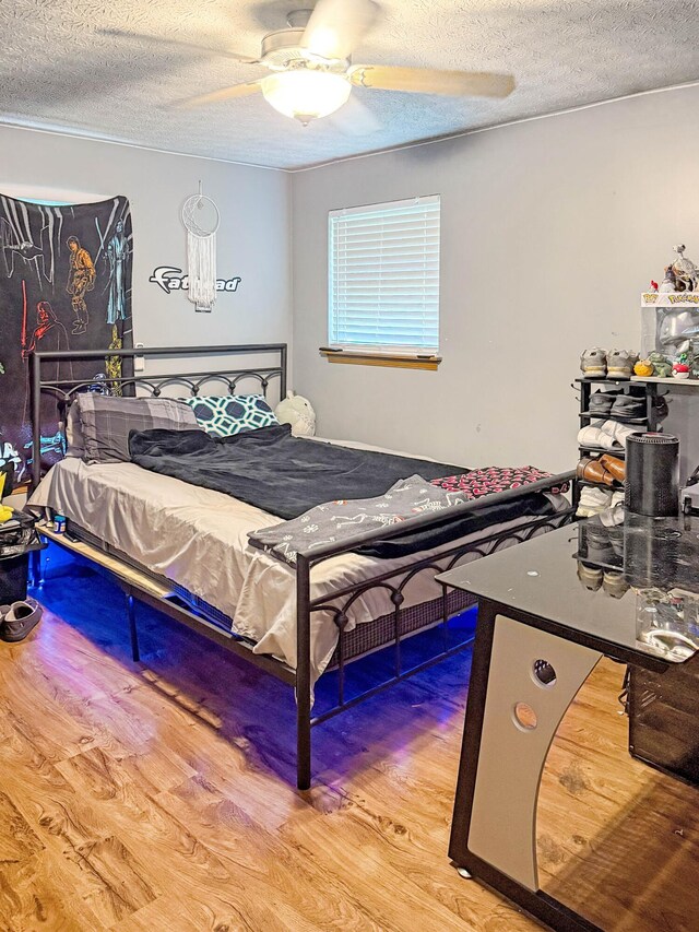 4890 Township Road 138 NW, Somerset, OH 43783 - bedroom featuring wood finished floors, a textured ceiling, and a ceiling fan