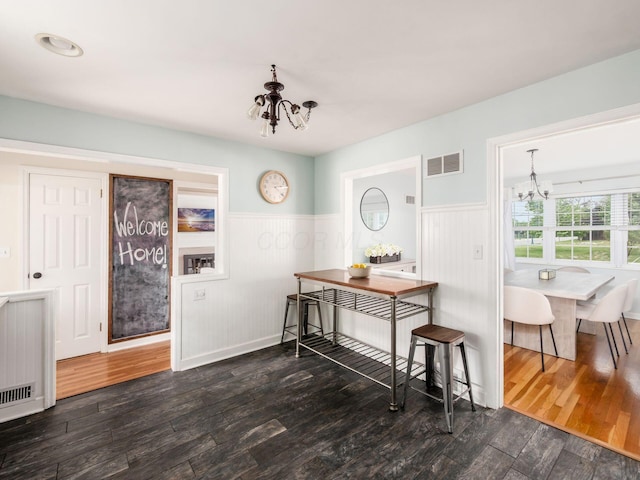 2805 Brandon Rd, Upper Arlington, OH 43221 - dining area featuring a chandelier, wainscoting, and wood finished floors