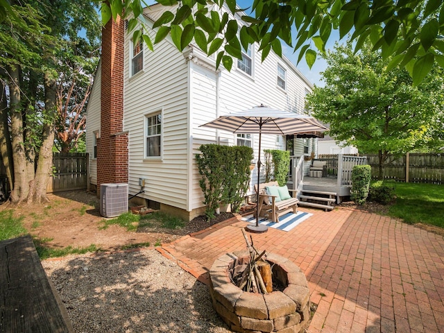2805 Brandon Rd, Upper Arlington, OH 43221 - back of property with an outdoor fire pit, a patio, a wooden deck, cooling unit, and a fenced backyard